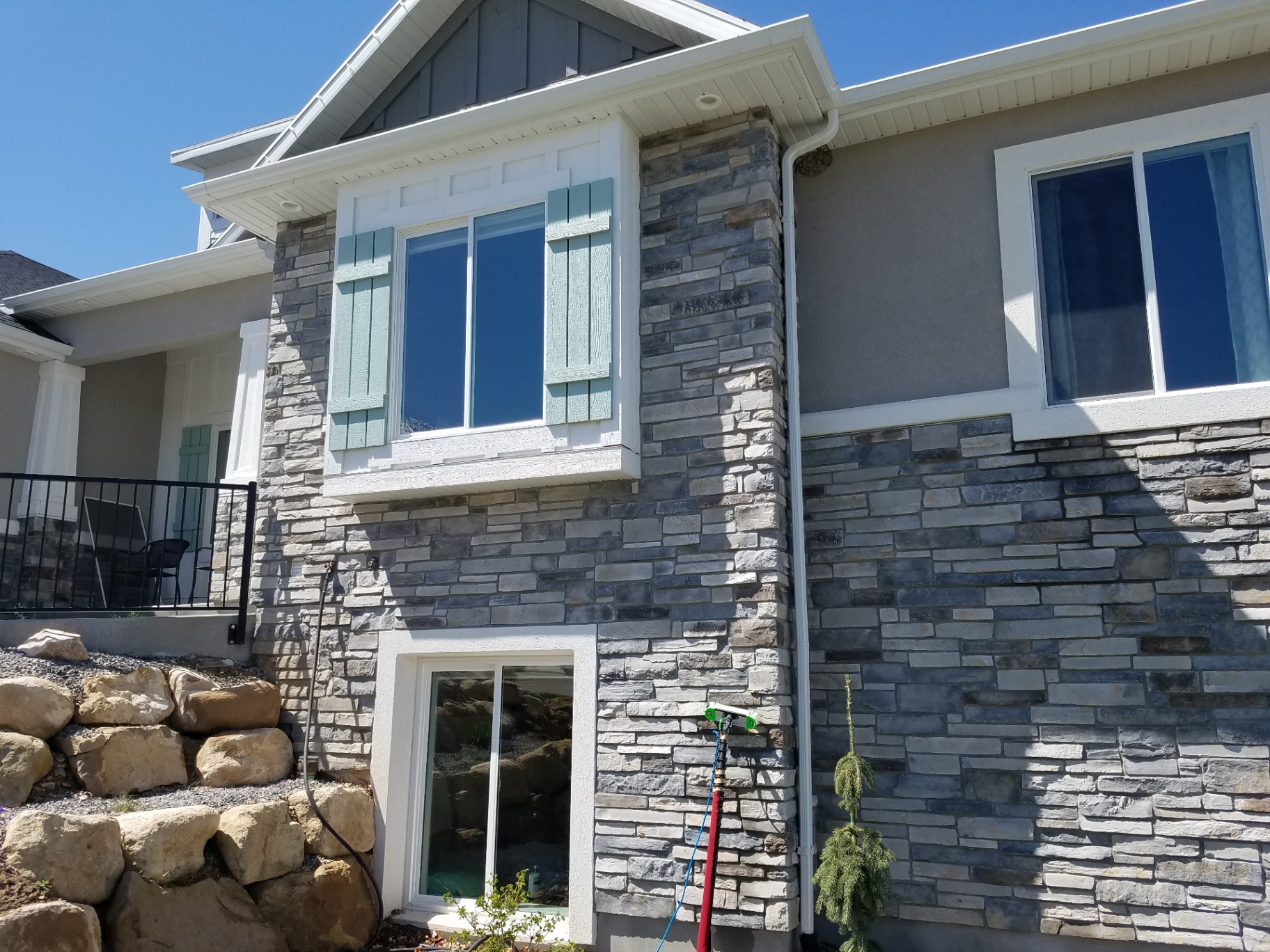 Purity Cleaning Systems technician washing residential windows in Utah County, UT